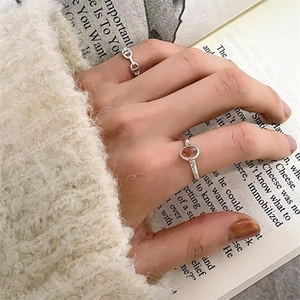 Detail of 925 sterling silver ring featuring a reddish-brown oval gemstone and textured band