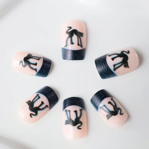 Short square press-on nails with black cat silhouettes and blue glitter gradients