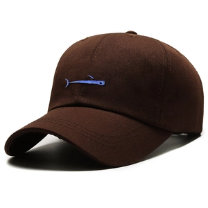 Brown cotton baseball cap featuring blue whale embroidery on a curved brim and stiff crown
