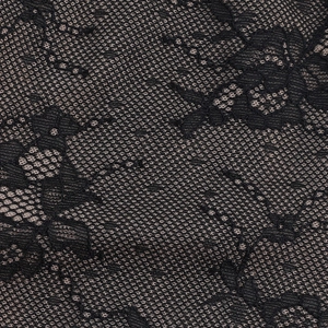 Close-up of dual-tone floral lace fabric with detailed black and beige mesh texture