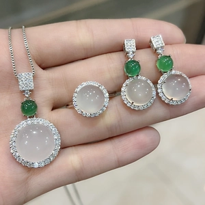 Detail of elegant silver jewelry set with translucent chalcedony and green gemstones