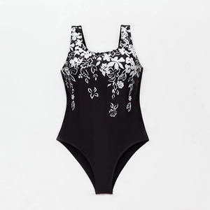 Detail of floral patterns and u-neck design on a black one-piece athletic swimsuit
