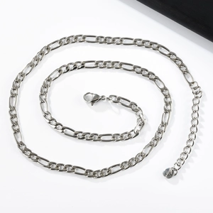 Detailed close-up of a silver Figaro steel chain with lobster clasp and round tag