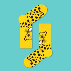 Detail view of yellow cotton socks featuring leopard print and cartoon cheetah jacquard