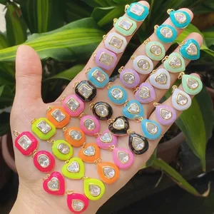Colorful enamel geometric charms with cubic zirconia and gold plating on hand