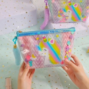 Close-up of translucent unicorn toiletry bag with glitter sequins and plush tail charm