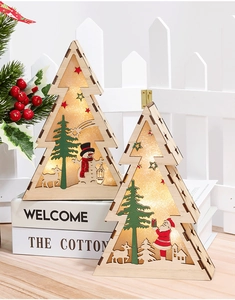 Detailed view of two wooden Christmas tree LED ornaments with snowman and Santa scenes
