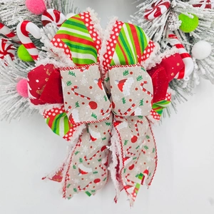 Christmas wreath with festive bow featuring candy cane stripes and red polka dot ribbons