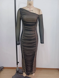 Detail of ruched black off-shoulder dress with sequined mesh and long sleeves