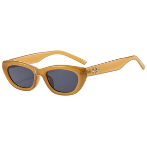 Retro cat-eye sunglasses with translucent amber frames and dark grey lenses on white background