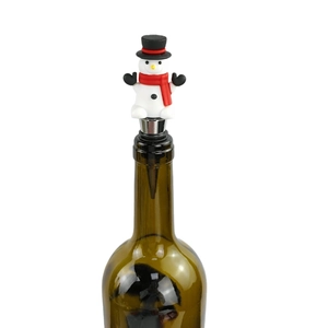 Detail of a snowman wine stopper with a red scarf and black hat on a metal base