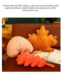 Detail of plush leaf pillows with smiley faces showing premium soft fabric and PP cotton filling