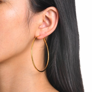 Side view of a model wearing a large 18k gold plated stainless steel hoop earring