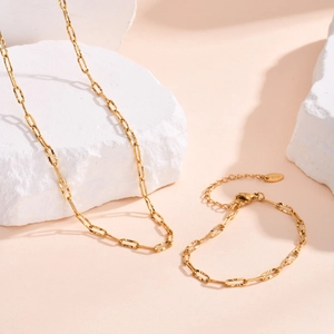 Detail of 18K gold necklace and bracelet set with textured oval links and lobster clasp
