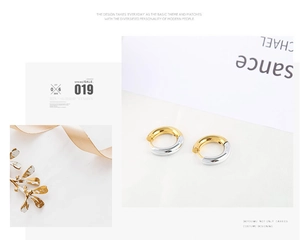 Detail view of 4mm stainless steel hoop earrings in gold and silver finish with silk props