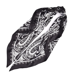 Macro detail of high-quality satin scarf with classic black and white paisley pattern