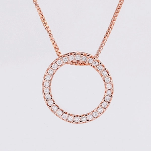 Detail of rose gold circle pendant with cubic zirconia on a box chain necklace