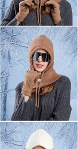 Close-up of winter balaclava knit hat with matching gloves showing texture and detail