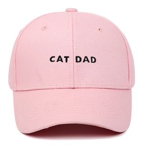 Close-up of black CAT DAD embroidery on pink cotton baseball cap with ventilation eyelets