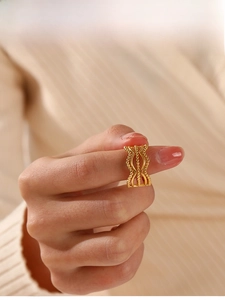Detail of gold hollowed triple-wave ring with delicate bead edges on model hand