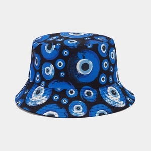 Close-up of Nazar evil eye pattern on a double-sided black cotton bucket hat fabric
