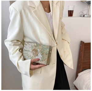 Detailed view of an oil painting style floral box bag with elegant sunflower patterns