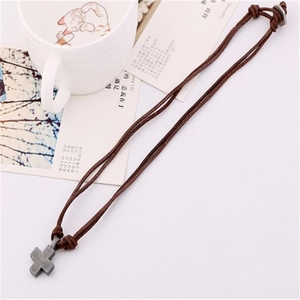 Vintage handmade leather cord necklace with a metallic cross pendant for men and women
