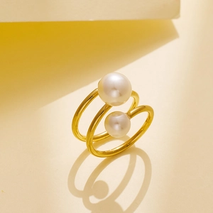 Detail of 18k gold plated double-layer wrap ring featuring two glossy white pearls