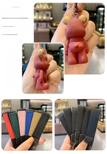 Macro detail of Nordic bear keychains with colorful woven straps and metal hooks