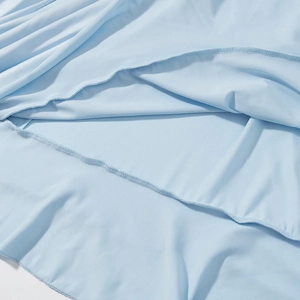 Detailed view of light blue bohemian skirt fabric texture and ruffled hem stitching