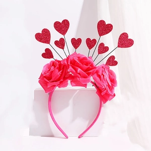 Detail of pink rose headband with red glitter hearts on wires for party wear