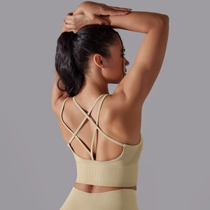 Detail of beige ribbed sports bra with criss-cross back straps and matching leggings