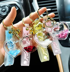 Detailed view of colorful quicksand heart-shaped keychains with matching wrist straps.