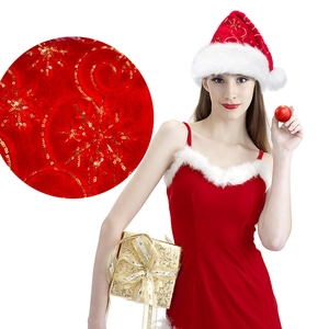 Detail of red velvet Christmas hat featuring gold sequins and soft plush texture