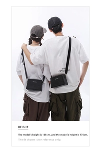 Couples wearing textured black box crossbody bags featuring CONE KNOWS white print
