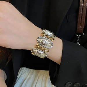Detail of vintage wide stretch bracelet with hammered silver panels and gold rope trim