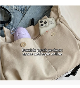 Detail of beige canvas crossbody bag showing large pockets for umbrella and smartphone