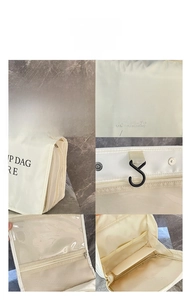 Detail view of cream makeup bag with hanging hook, mesh dividers and waterproof fabric