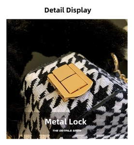 Detail of golden rectangular twist lock on houndstooth fabric with black faux fur handle