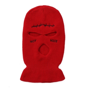 Detail of red 3-hole knitted balaclava with 'NOT NICE' and barbed wire embroidery