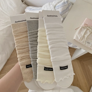 Summer knit leg warmers in four colors displayed in a soft bedroom setting