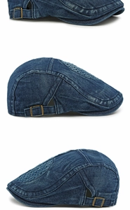 Detail view of washed denim flat top cap featuring bronze metal adjustable buckle
