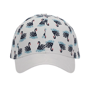 Detail of white cotton baseball cap showing black swan pattern with red beaks and blue waves