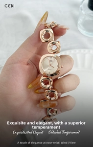 Macro shot of rose gold quartz watch with geometric openwork bracelet and rhinestone dial