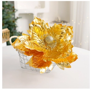 Close-up of artificial gold Christmas flower with glitter detail in a wire basket