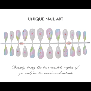 Detail of almond press-on nails with 3D white flower carving and pastel gradient design