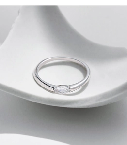 Detailed view of s925 sterling silver ring with marquise-cut crystal on ceramic stand