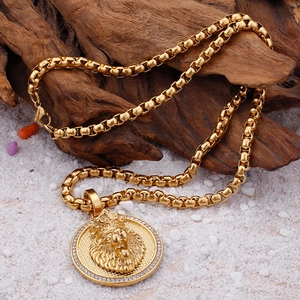 Detailed close-up of a golden hip-hop lion head pendant with sparkling rhinestones