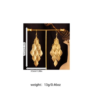 Detailed view of gold leaf drop earrings with 10.5cm length and 13g weight specs