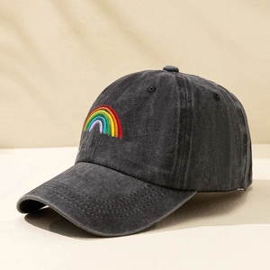 Detail of rainbow embroidery on washed black cotton baseball cap with vintage look